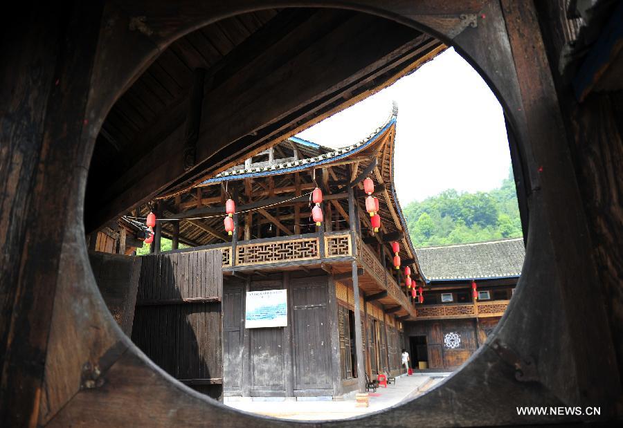 Photo taken on June 16, 2013 shows the wooden Diaojiaolou, or stilted houses in Shiyanping Village, Wangjiaping Township of Zhangjiajie City in central China's Hunan Province. 