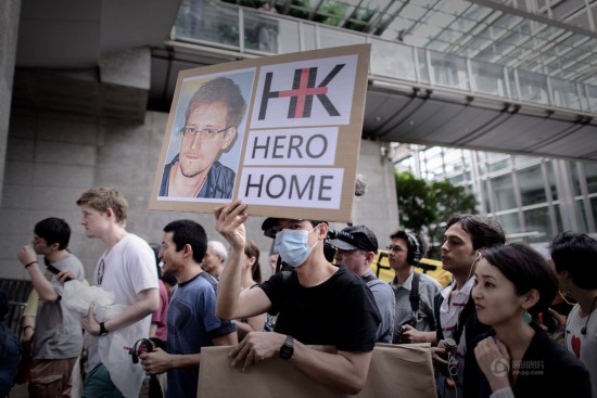 A man holds a poster in a demonstration of support for Edward Snowden in Hong Kong on June 15.