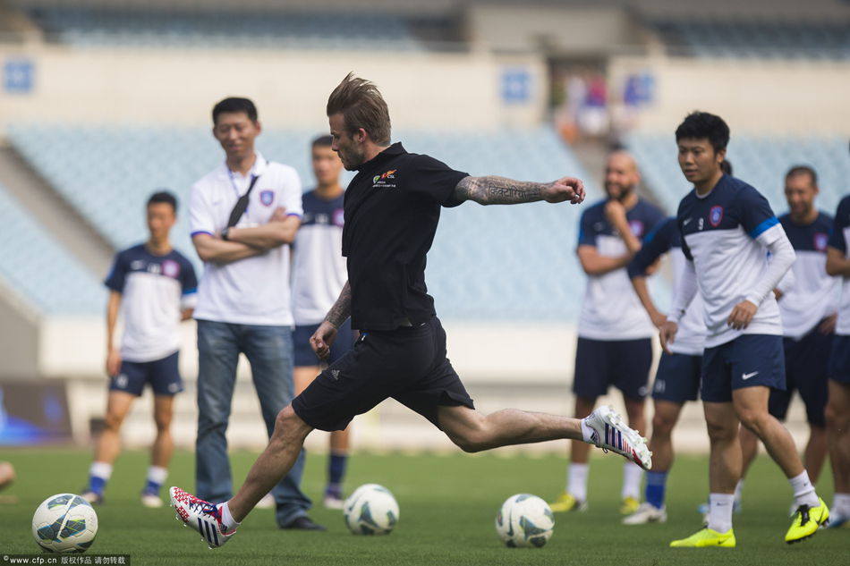 David Beckham shows off his trade mark free kicks during a training session with Jiangsu Sainty players at Nanjing Olympic Sports Center on June 18, 2013 in Nanjing, Jiangsu Province of China. 