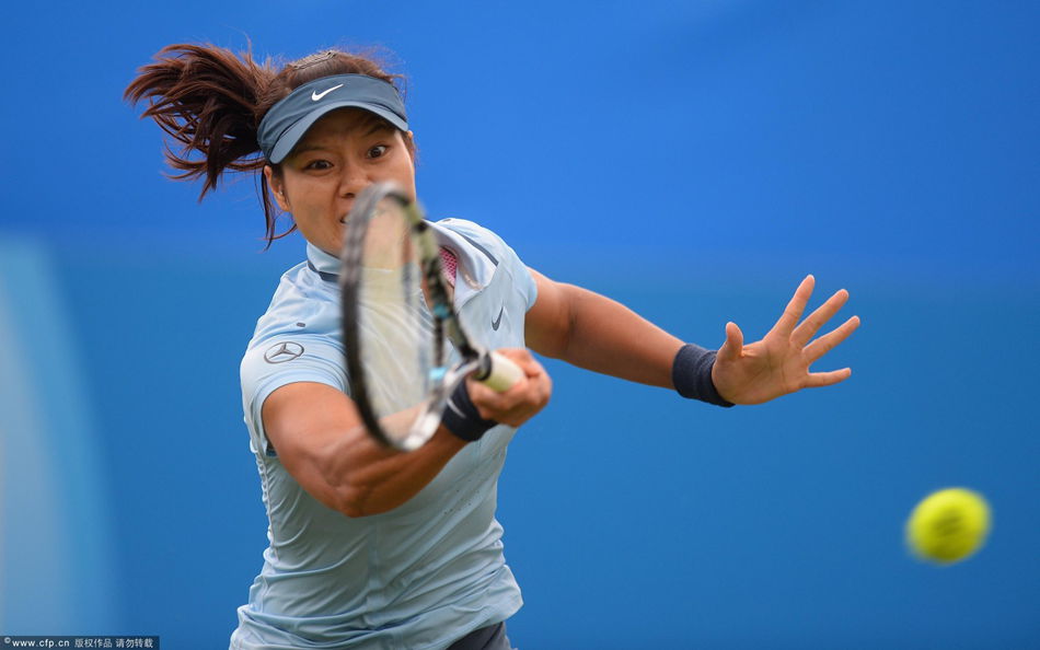 Li Na hits a return during her women's singles match against Alize Cornet in the first round of the AEGON International tennis tournament in Eastbourne on Tuesday. 