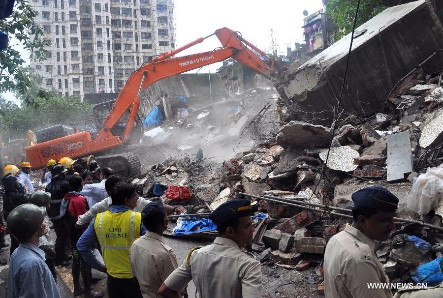 Rescuers work at the site of collapsed four-storey building in suburban Dahisar on the outskirts of Mumbai, on June 22, 2013.The building collapsed on Saturday caused five people dead and several wounded. (Xinhua/Stringer)