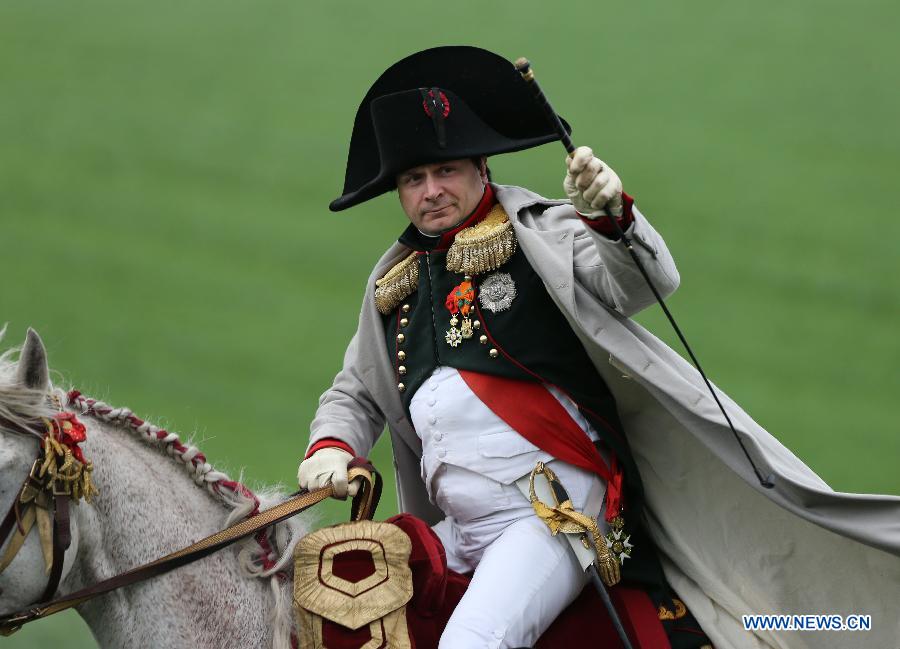 A history enthusiast dressed as Louis-Napoleon takes part in the reenactment of the famous 1815 Waterloo battle near Waterloo outside Brussels, Belgium, June 22, 2013. (Xinhua/Gong Bing)