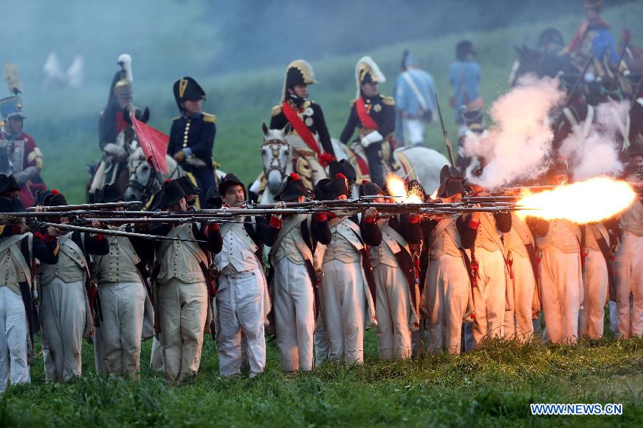 History enthusiasts take part in the reenactment of the famous 1815 Waterloo battle near Waterloo outside Brussels, Belgium, June 22, 2013. (Xinhua/Gong Bing)