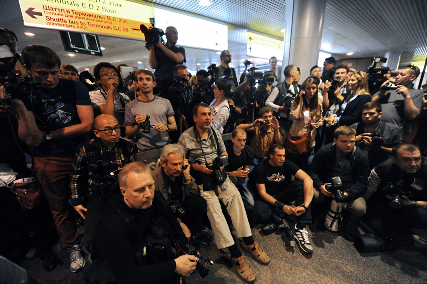 Russian journalists wait for the arrival of former US spy Edward Snowden at the Moscow Sheremetevo airport on June 23, 2013. 