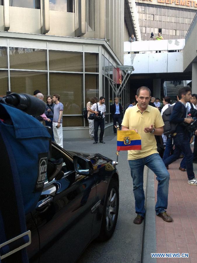 Media reporters work beside a vehicle of the Ecuadorian Embassy in Moscow, June 23, 2013. According to Russian media reports, Snowden arrived in Moscow from Hong Kong on Sunday on a commercial flight and the Ecuadorian ambassador in Moscow was waiting for him at the Sheremetyevo airport.