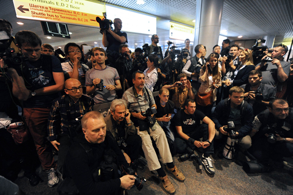 Russian journalists wait for the arrival of former U.S. spy Edward Snowden at the Moscow Sheremetevo airport on June 23, 2013. 