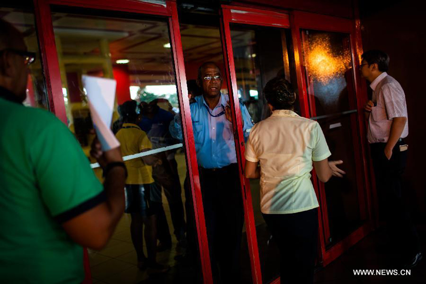 A staff closes an exit to the flight SU150 from Moscow, Russia, due to the emergency of too many journalists at the Jose Marti airport in Havana, Cuba, June 24, 2013. Former U.S. intelligence contractor Edward Snowden did not show up at the flight.