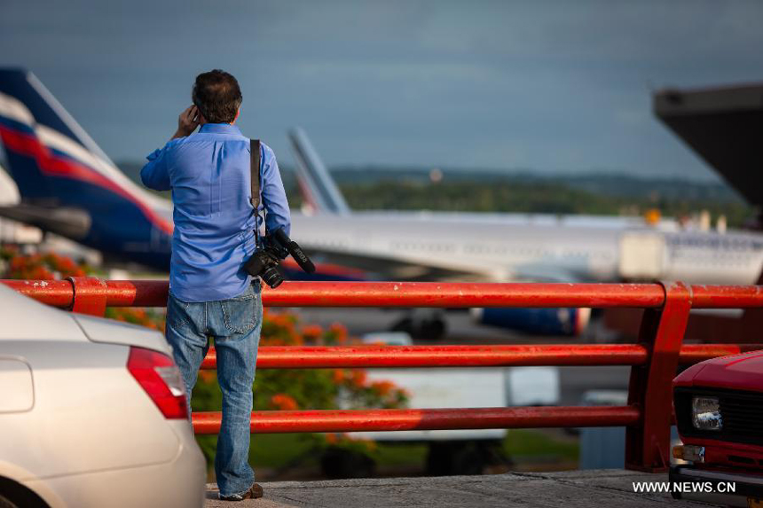 A reporter speaks on the mobile on seeing the flight SU150 from Moscow, Russia, at the Jose Marti airport in Havana, Cuba, June 24, 2013. Former U.S. intelligence contractor Edward Snowden did not show up at the flight.