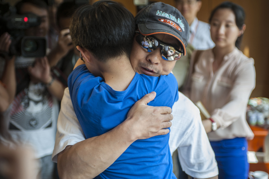 Zhang Jingchuan, the only survivor of a four-member Chinese amateur mountaineering team following a Taliban terrorist attack in northern Pakistan on Sunday, are greeted by his family at the airport in Kunming, Yunnan Province, on June 26. Two Chinese civilian mountaineers and a Chinese American were among the 11 people killed in a pre-dawn terrorist attack in Pakistan-administered Kashmir on Sunday. [Photo/Xinhua] 