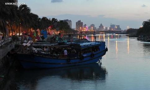 Ships stay at Xinbu island in Haikou, capital of south China's Hainan Province, June 30, 2013. 