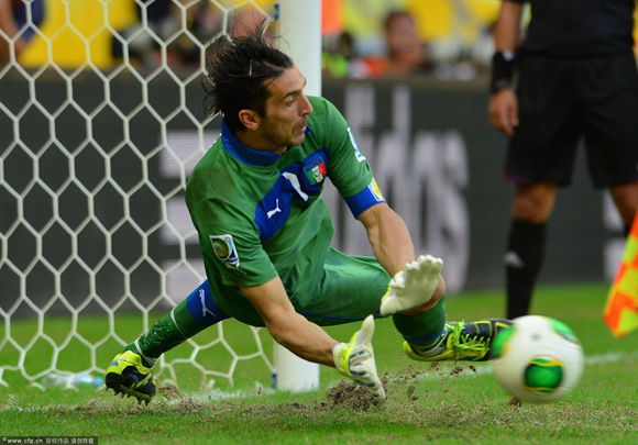 Gianluigi Buffon of Italy saves the penalty of Walter Gargano of Uruguay to clinch victory in a shootout during the FIFA Confederations Cup Brazil 2013 3rd Place match between Uruguay and Italy at Estadio Octavio Mangabeira (Arena Fonte Nova Salvador) on June 30, 2013 in Salvador, Brazil.