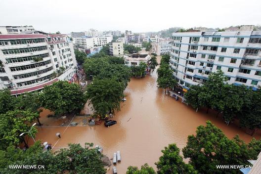 Photo taken on July 1, 2013 shows waterlogged roads in Tongliang County of Chongqing, southwest China. Rainstorms swept the county on Sunday and Monday, waterlogging roads and houses. 
