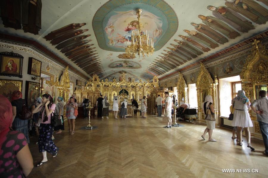 Tourists visit the Kiev-Pechersk Lavra in Kiev, Ukraine, July 2, 2013. Kiev-Pechersk Lavra is nominally divided into two parts: the Upper Lavra, where the museums, shops and churches are situated and the Lower Lavra, underground area, where mummified bodies of Orthodox Saints are conserved. 