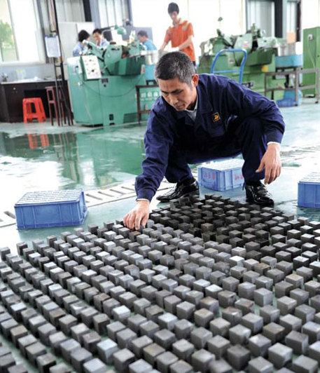 A worker dries neodymium iron, a kind of rare earth, at Jiangxi Leiyuan Magnet Material Co Ltd in Ganzhou, Jiangxi province. Ganzhou is one of China's major mining centers for these elements.