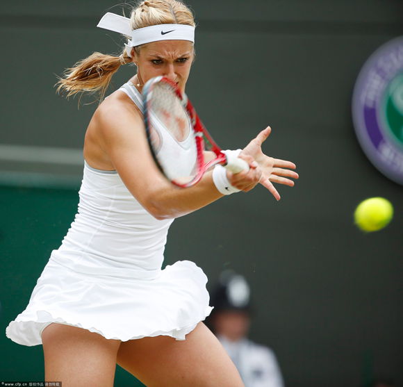 Sabine Lisicki of Germany returns to Kaia Kanepi of Estonia during their quarter-final match for the Wimbledon Championships at the All England Lawn Tennis Club, in London, Britain, 02 July 2013. 