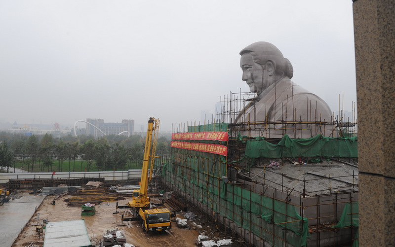 The 27-meter stone statue of Soong Ching Ling (1893-1981) under construction in Zhengzhou, Henan Province, in November 2011. [Photo/Xinhua]