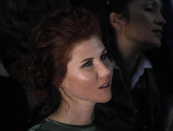 Anna Chapman, who pleaded guilty to being an unregistered foreign agent for Russia while living in the United States and agreed to be deported to Russia in July 2010, watches the Alena Akhmadullina show during Volvo fashion week in Moscow October 31, 2011. [Xinhua] 