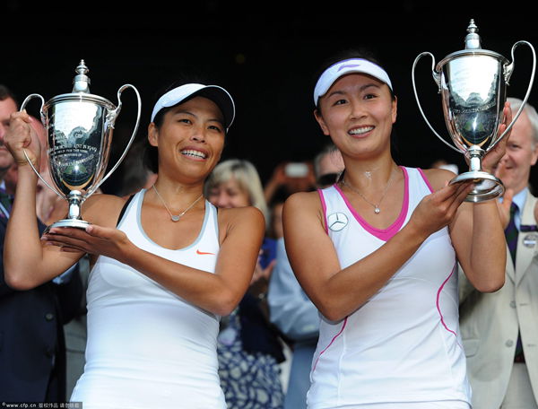 Su-Wei Hsieh (L) and Shuai Peng celebrate with their trophies after winning the women's doubles final for the Wimbledon Championships at the All England Lawn Tennis Club, in London, Britain, 06 July 2013.