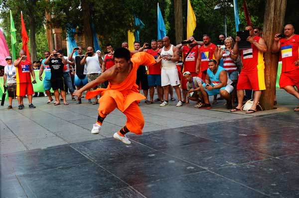 Shaolin monks perform kung fu for visiting competitors in the 2013 China World Strongman Championship on Sunday. 