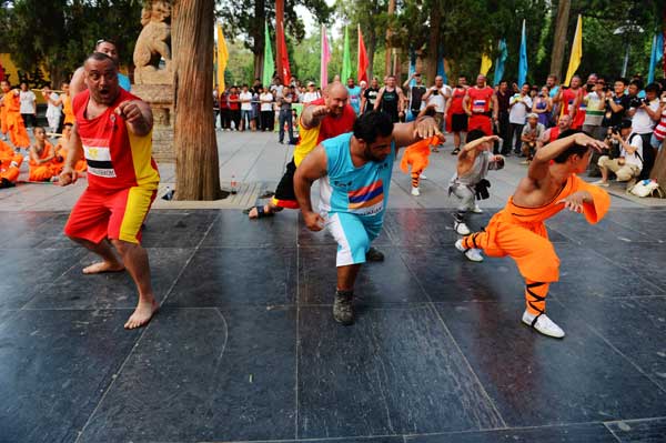 Strongman contestants learn Chinese martial arts at Shaolin Temple in Zhengzhou, Henan province, on Sunday afternoon. 