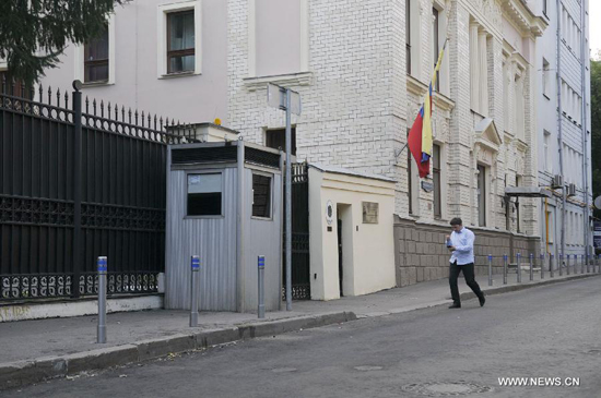 A man passes by the Venezuelan Embassy to Russia in Moscow, July 9, 2013. U.S. intelligence contractor Edward Snowden has agreed to seek political asylum in Venezuela, a senior Russian lawmaker said on Tuesday. (Xinhua