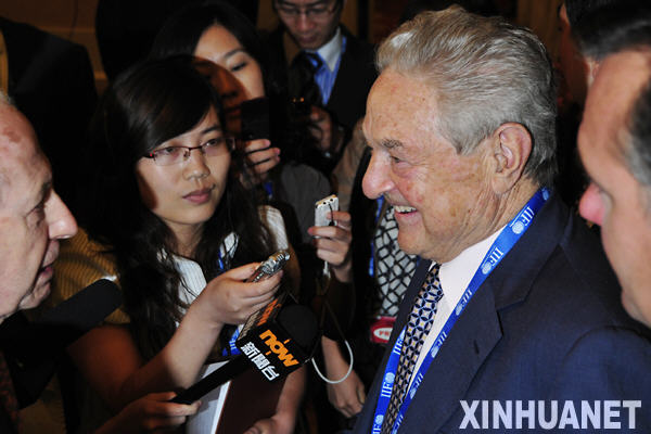 Legendary investor George Soros speaks with reporters. 