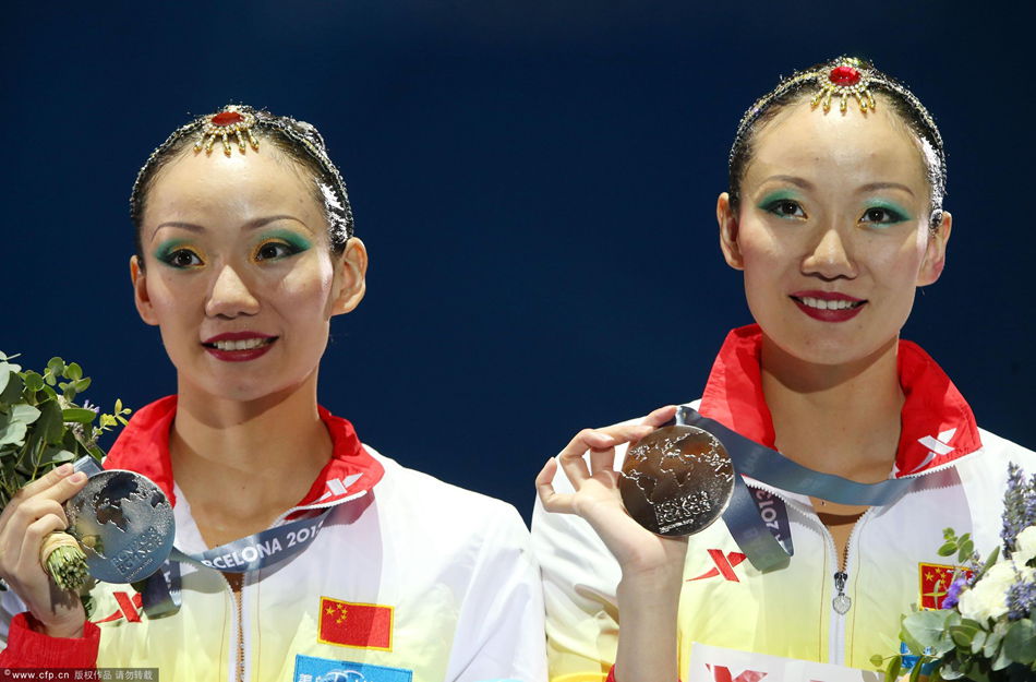 China's twin sisters of Jiang Wenwen and Jiang Tingting in action to win the silver medal in the synchronised swimming's duet technical routine as part of 15th FINA World Championships at Palau Sant Jordi pavilion in Barcelona, north-eastern Spain, 21 July 2013.