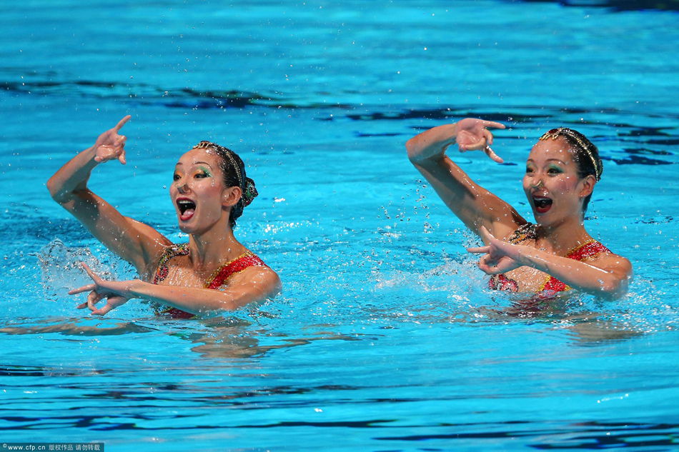 China's twin sisters of Jiang Wenwen and Jiang Tingting in action to win the silver medal in the synchronised swimming's duet technical routine as part of 15th FINA World Championships at Palau Sant Jordi pavilion in Barcelona, north-eastern Spain, 21 July 2013.