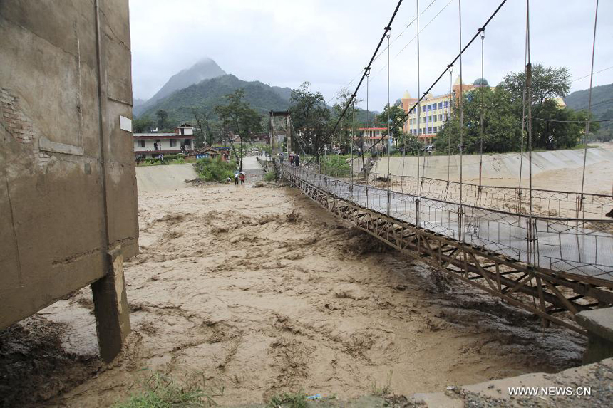 Floodwater is seen in a river in Huangzhu Town of Chengxian County, northwest China&apos;s Gansu Province, July 25, 2013. A torrential rain battered Chengxian County from Wednesday night to Thursday morning, causing landslide and traffic disruption.
