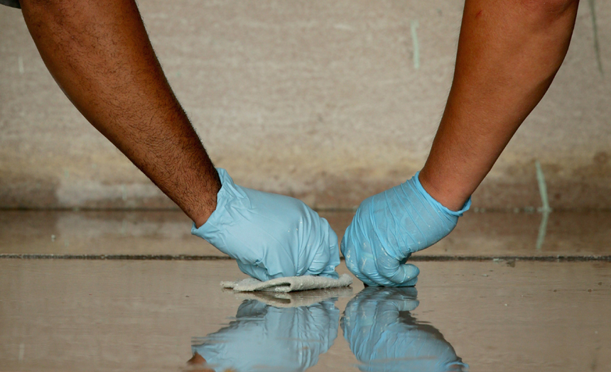 U.S. National Park Service employees use a variety of tools, including razor blades, plastic paint scrapers, sponges, solvents and a pressure washer, to clean the Lincoln Memorial after it was vandalized with a splatter of green paint July 26, 2013 in Washington, DC.