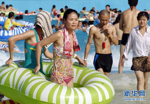People enjoy themselves in a water park in Shanghai to drive away summer heat. The city experienced a record-high temperature of 40.6 degrees Celsius on July 26