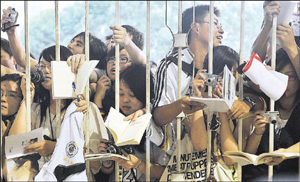 Young people crave for autograph of their hero during a fans meeting in Shanghai.