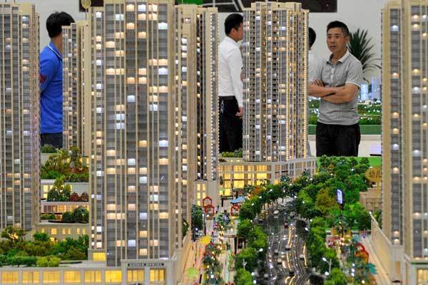 Buyers choose houses at a sales room in Guiyang, capital of Guizhou province. The average price of new homes in the 100 monitored cities reached 10,347 yuan ($1,688) per square meter in July. 