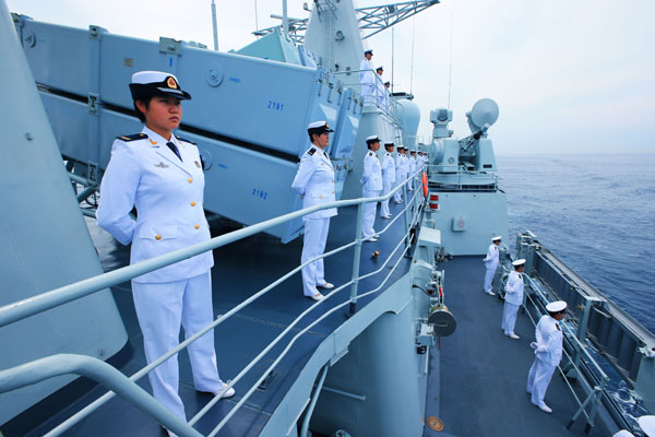 Soldiers and officials on the Shenyang, a Chinese naval ship, are inspected during the Joint Sea 2013 Drill with Russia in Peter the Great Gulf near Russia's Far East port city of Vladivostok in July. The last of the seven warships that took part in the drill returned to China on Sunday.Zha Chunming / Xinhua News Agency  