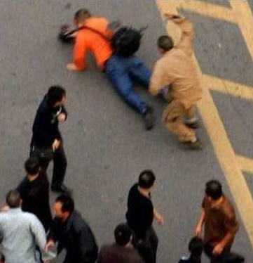 An undated photo shows several monks beating a common person. [Internet photo] 