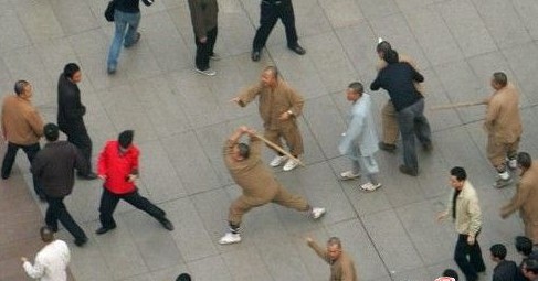 An undated photo shows several monks beating a common person. [Internet photo] 