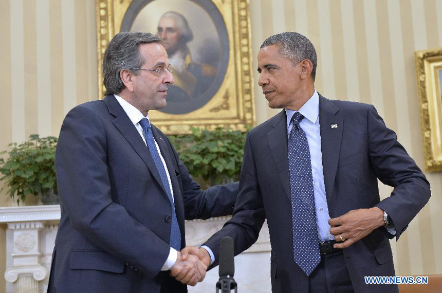 U.S. President Barack Obama (R) shakes hands with visiting Greek Prime Minister Antonis Samaras after their meeting in the Oval Office of the White House in Washington D.C., capital of the United States, Aug. 8, 2013.