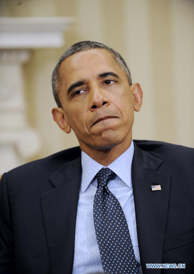 U.S. President Barack Obama reacts while speaking to the media after meeting with visiting Greek Prime Minister Antonis Samarasin the Oval Office of the White House in Washington D.C., capital of the United States, Aug. 8, 2013.