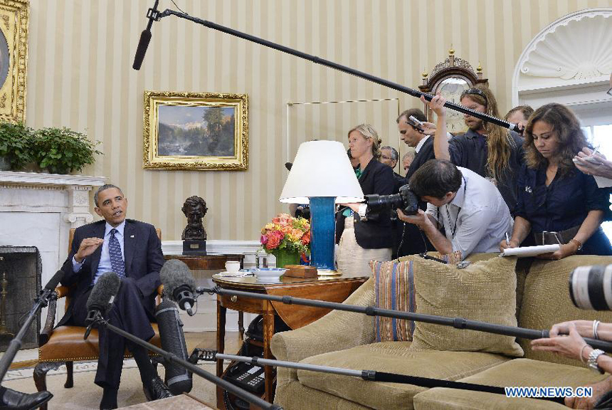 U.S. President Barack Obama speaks to the media after meeting with visiting Greek Prime Minister Antonis Samarasin the Oval Office of the White House in Washington D.C., capital of the United States, Aug. 8, 2013. 