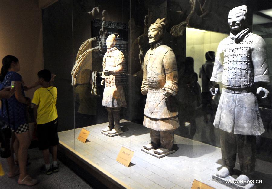 Tourists visit the terracotta warriors and horses at the Emperor Qinshihuang's Mausoleum Site Museum in Xi'an, capital of northwest China's Shaanxi Province, Aug. 20, 2013. 