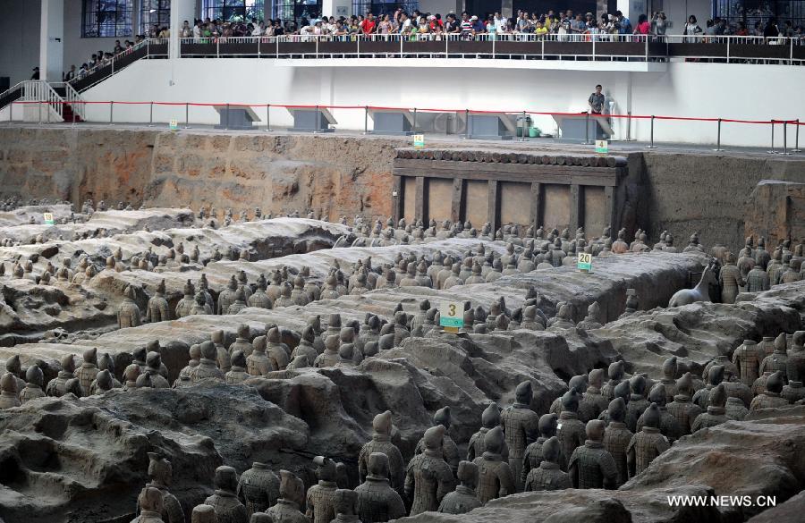 Tourists visit the terracotta warriors and horses at the Emperor Qinshihuang's Mausoleum Site Museum in Xi'an, capital of northwest China's Shaanxi Province, Aug. 20, 2013. 