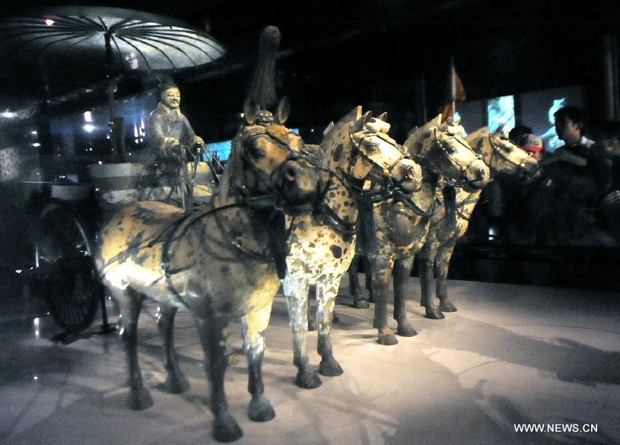 Tourists visit the terracotta warriors and horses at the Emperor Qinshihuang's Mausoleum Site Museum in Xi'an, capital of northwest China's Shaanxi Province, Aug. 20, 2013. 