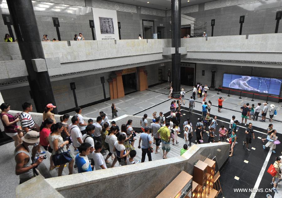 Tourists visit the terracotta warriors and horses at the Emperor Qinshihuang's Mausoleum Site Museum in Xi'an, capital of northwest China's Shaanxi Province, Aug. 20, 2013. 