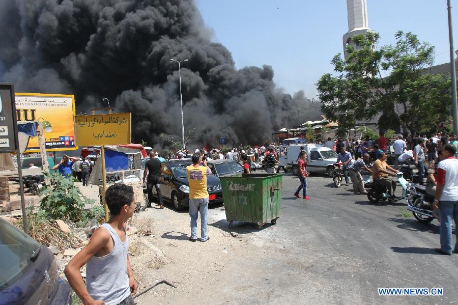 Smoke rises from the blast site in Tripoli, Lebanon, Aug. 23, 2013. At least 27 people were killed and 358 others injured on Friday when two powerful explosions rocked Lebanon's northern port city of Tripoli, the country's caretaker Health Minister Ali Hassan Khalil told reporters. [Omar/Xinhua]