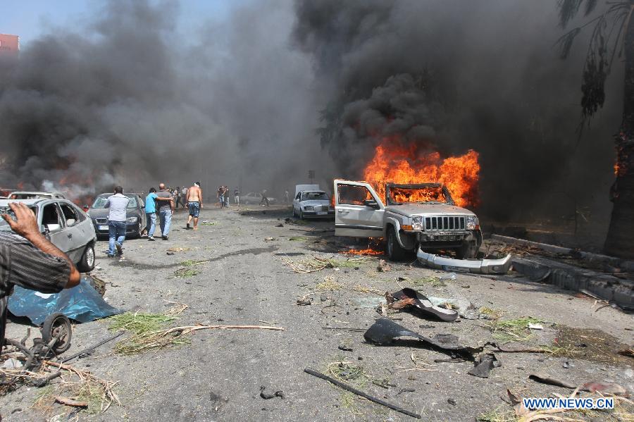 A car burns at the blast site in Tripoli, Lebanon, Aug. 23, 2013. At least 27 people were killed and 358 others injured on Friday when two powerful explosions rocked Lebanon's northern port city of Tripoli, the country's caretaker Health Minister Ali Hassan Khalil told reporters. [Omar/Xinhua]