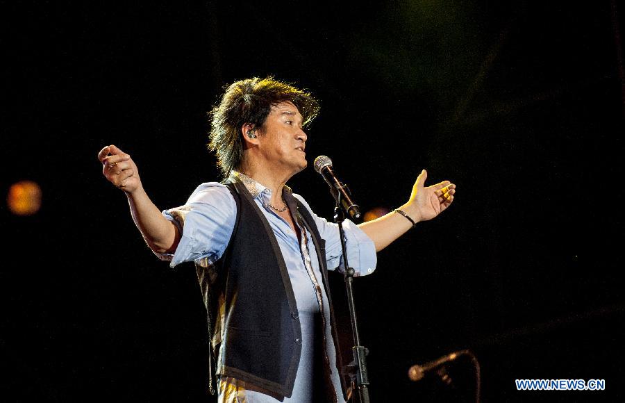 Singer Emil Wakin Chau performs during the Fun Music Festival in Fangshan District, Beijing, China, Aug. 23, 2013. The three-day music event kicked off here Friday, featuring a strong line-up of pop bands. [Zhang Yu/Xinhua]