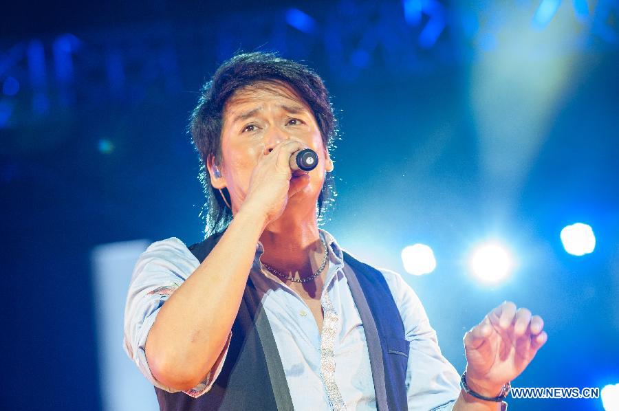 Singer Emil Wakin Chau performs during the Fun Music Festival in Fangshan District, Beijing, China, Aug. 23, 2013. The three-day music event kicked off here Friday, featuring a strong line-up of pop bands. [Zhang Yu/Xinhua]