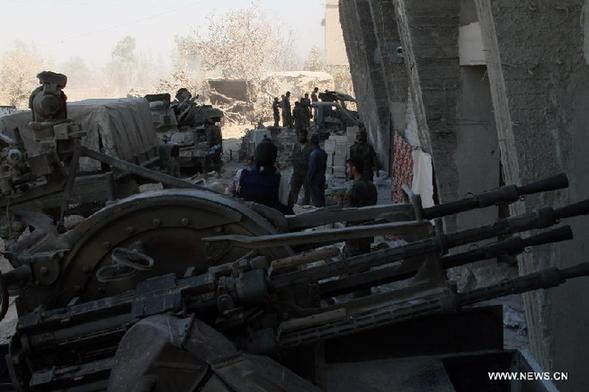 Syrian soldiers are seen at the battlefront of Jobar, near the capital of Damascus, on Aug. 24, 2013. Some Syrian soldiers on Saturday suffered suffocation after rebel militants released chemical substance around their hideouts near Damascus, the state-TV reported. [Bassem Tellawi/Xinhua]