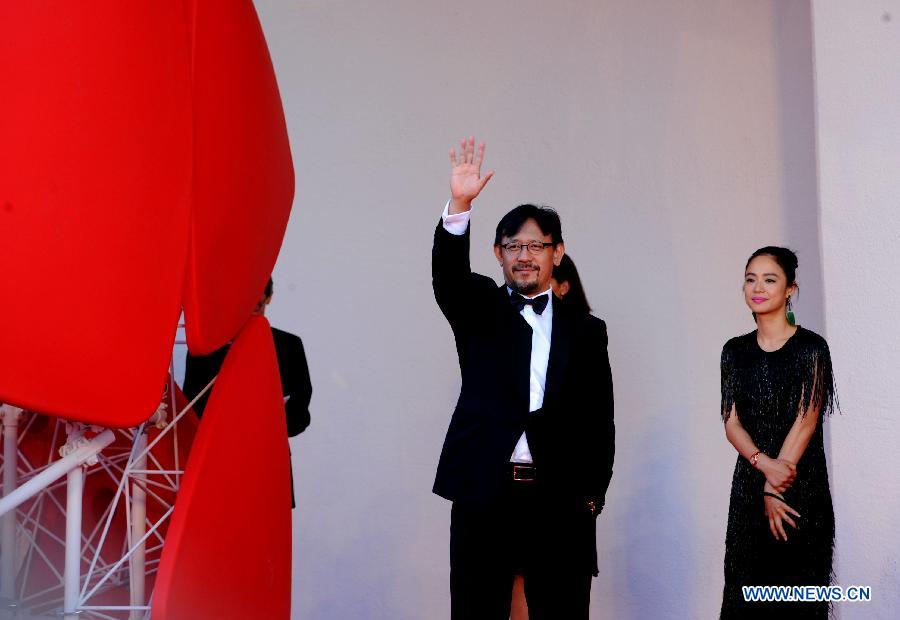 Chinese director Jiang Wen and his wife Zhou Yun show on the red carpet of the opening ceremony of the 70th edition of Venice Film Festival on lido island, Venice, on August 28, 2013.[Xu Nizhi/Xinhua]