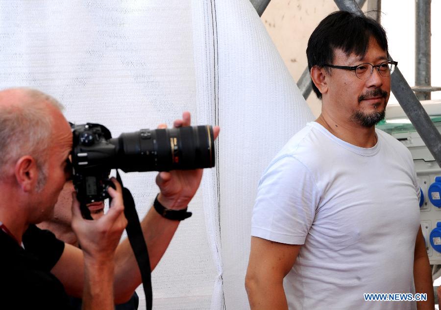 Chinese actor and director Jiang Wen (R), one of the jury members of Venezia 70 section, poses during a photocall at the Lido Casino, on the first day of the 70th Venice Film Festival, in Venice, Italy, on Aug. 28, 2013. [Xu Nizhi/Xinhua]
